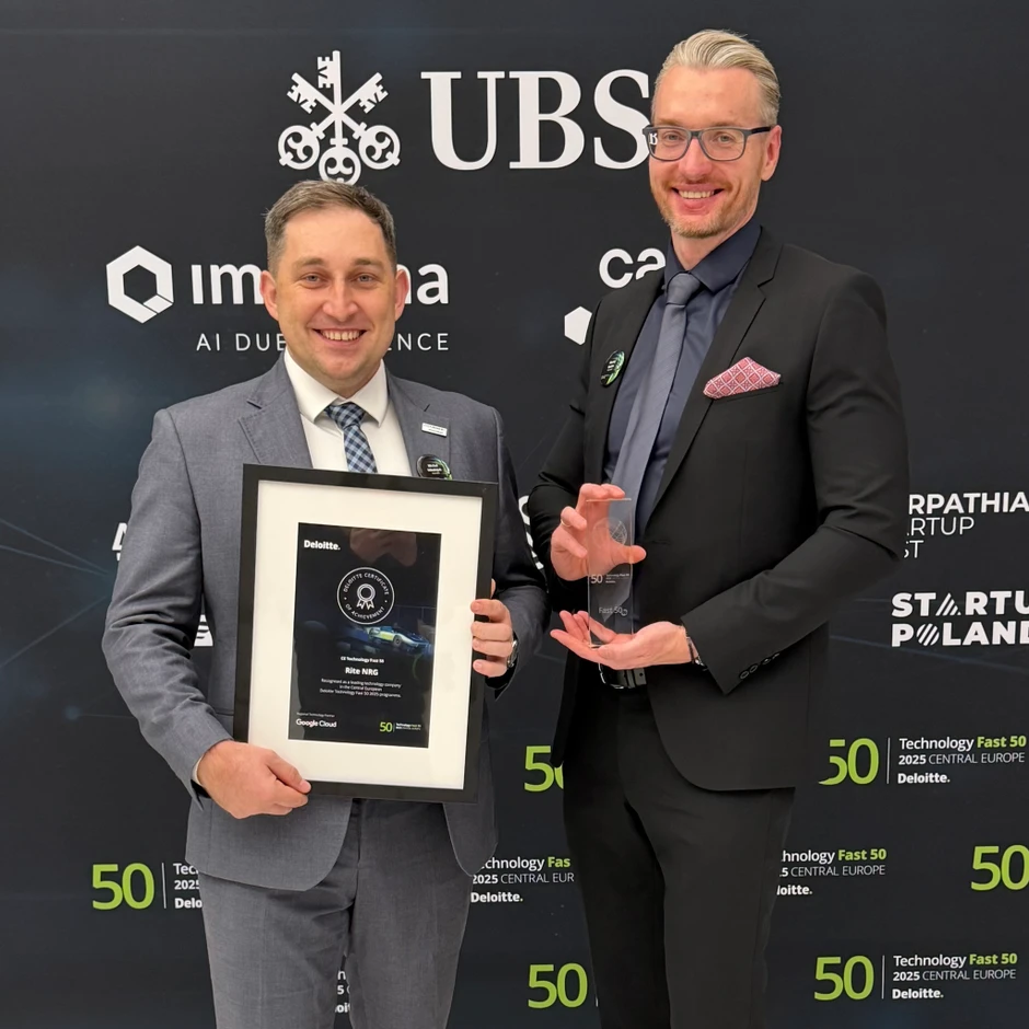 Dwóch mężczyzn w garniturach dumnie prezentuje nagrodę i certyfikat technologiczne na tle baneru Deloitte i UBS